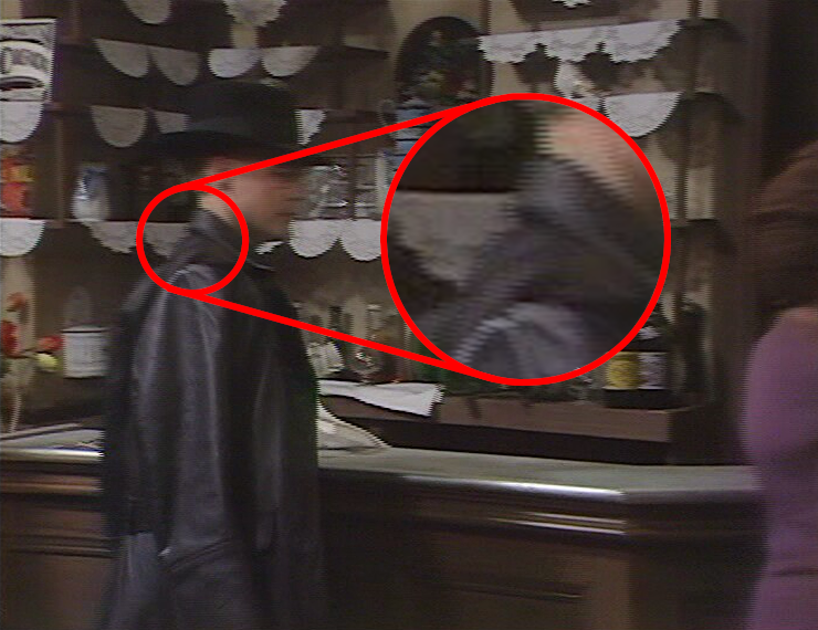 A shot from 'Allo 'Allo in which Herr Otto Flick is moving in front of the bar. Combing artifacts are clearly visible at the edge of his hat and chin.